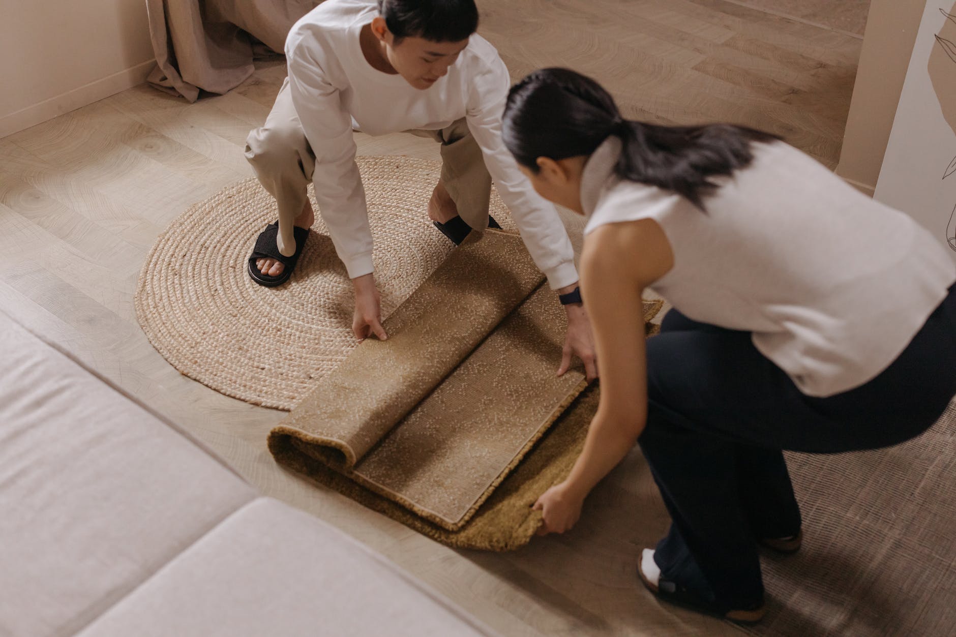 man in white dress shirt and black pants holding brown wooden chopping board